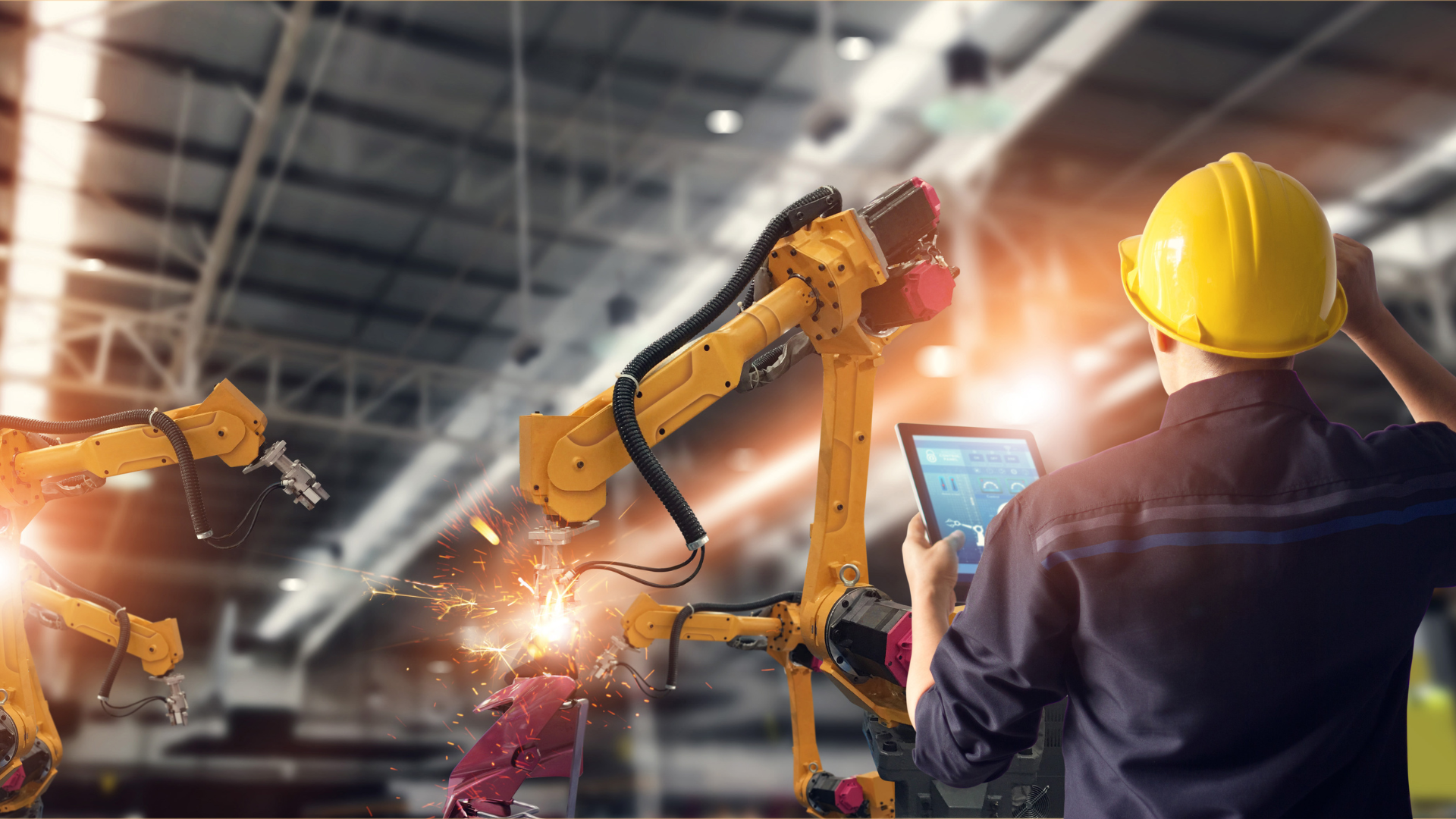 A technology manufacturer overseeing robotic machinery, representing resilience and growth achieved through business funding and a business line of credit.